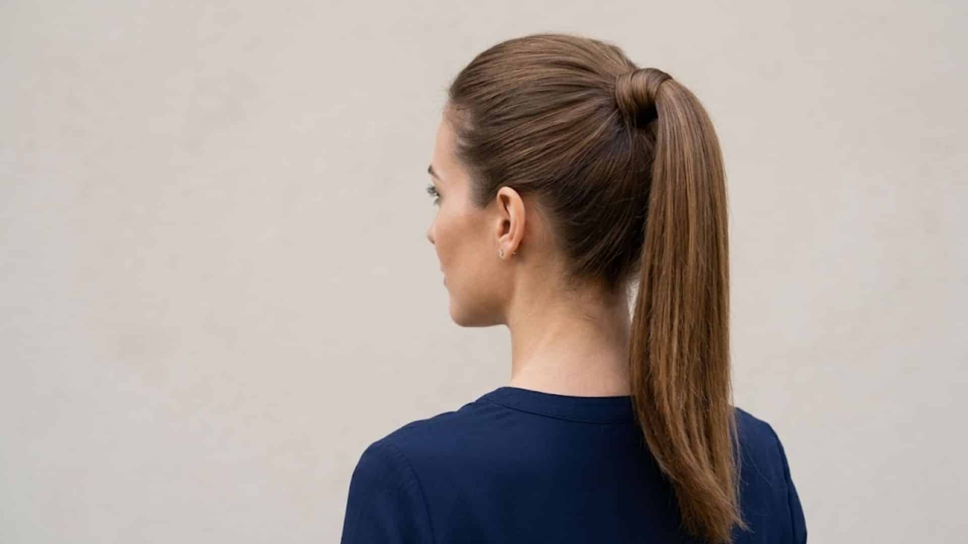 Sleek high ponytail with a wrapped strand hiding the hair tie
