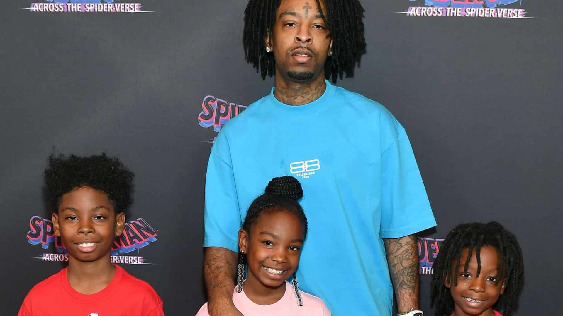 21 Savage posing with his children at the Spider-Man: Across the Spider-Verse premiere event