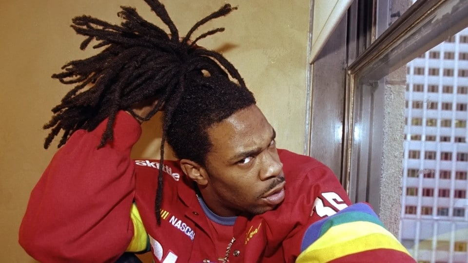 American rapper and hip-hop icon Busta Rhymes posing with his signature high-pony dreadlocks