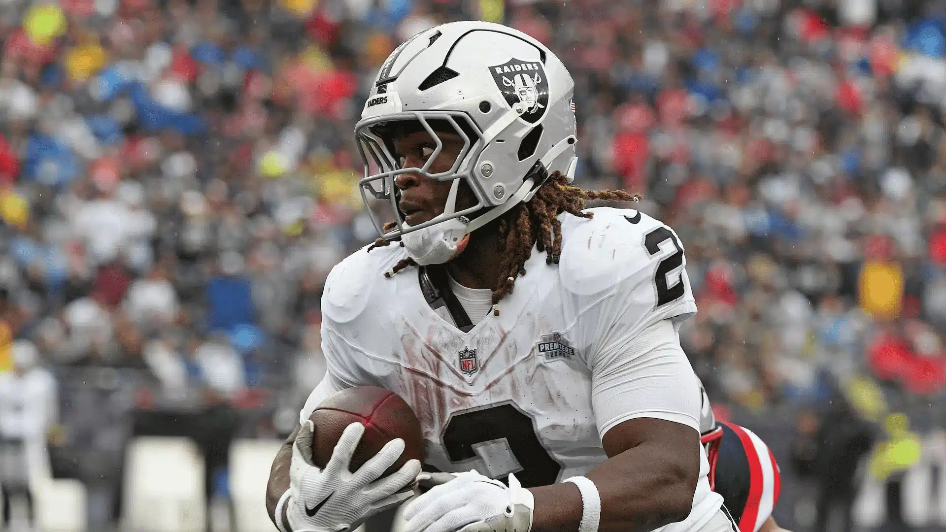 Ashton Jeanty carries the football while running for the Las Vegas Raiders
