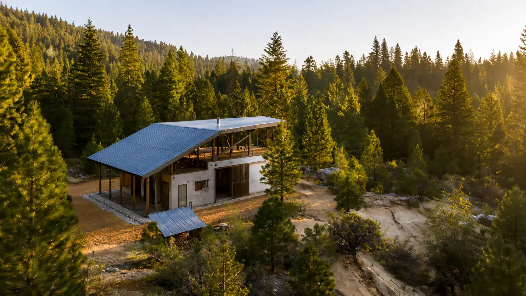 Bow Wow's home with metal roof nestled among evergreen trees and rocky terrain in a peaceful setting