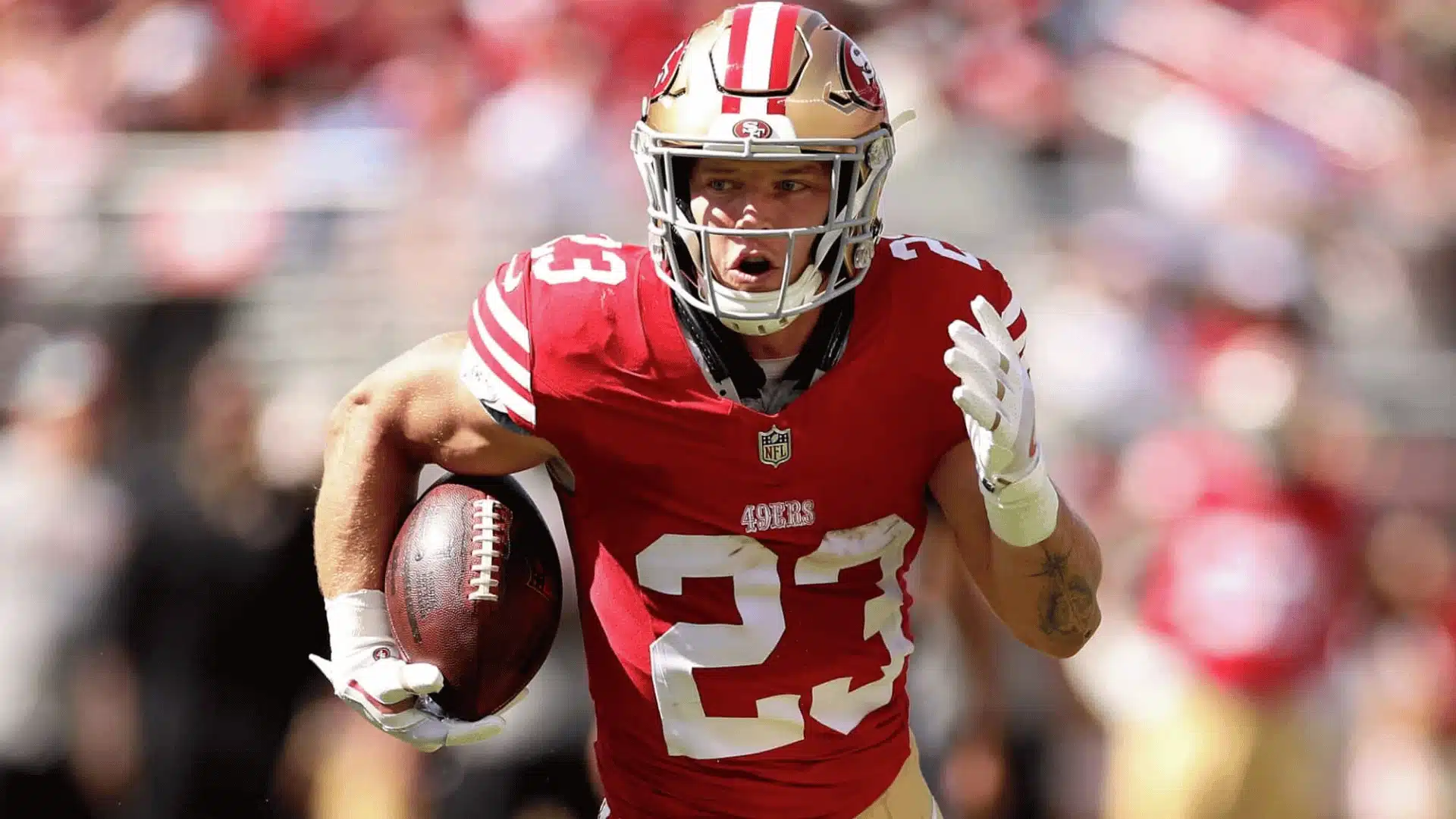 Christian McCaffrey carries the football while running for the San Francisco 49ers