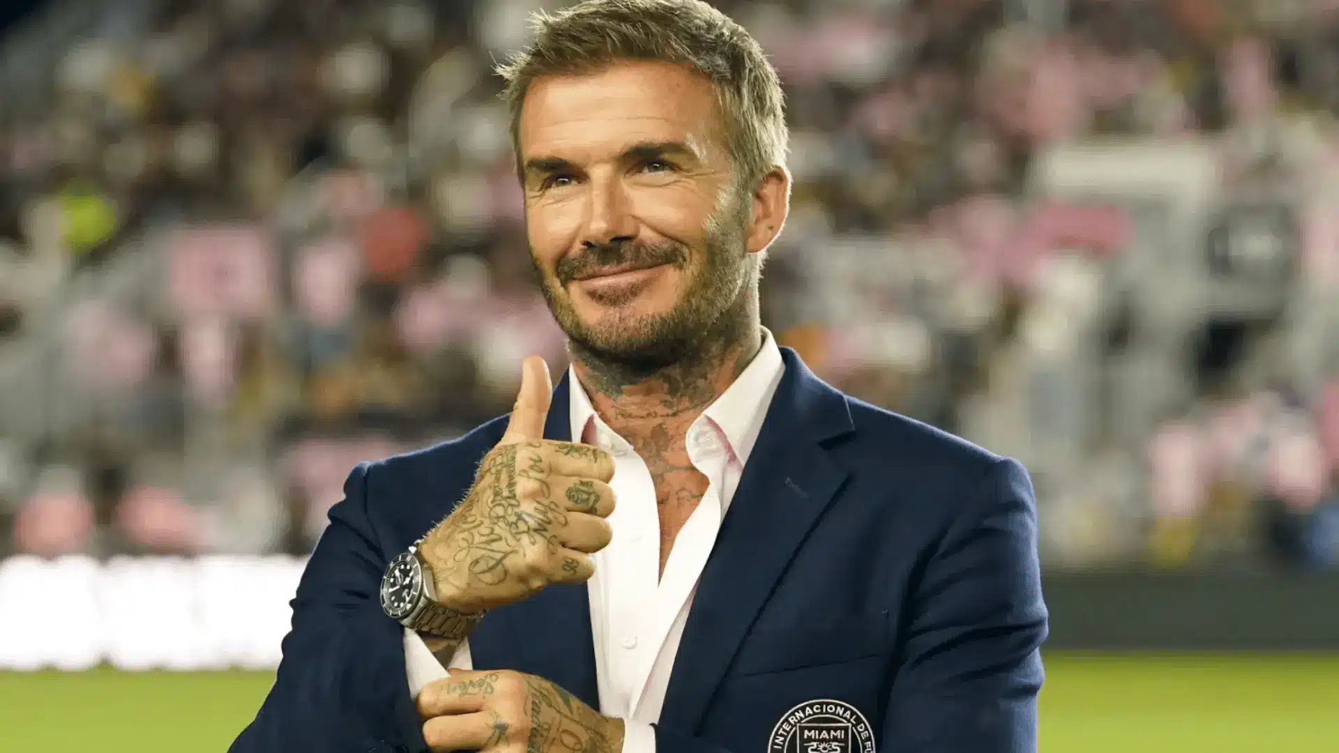 David Beckham gives a thumbs-up while wearing an Inter Miami suit at the club’s stadium.