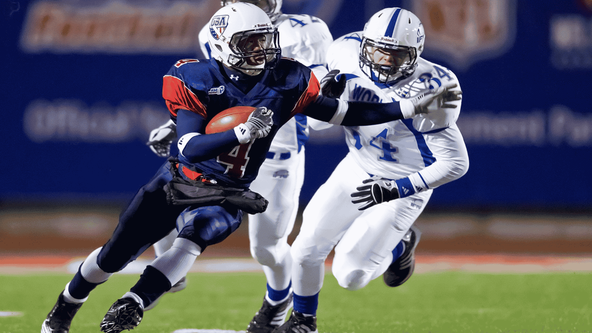 American football player running with the ball while stiff-arming a defender during a game.