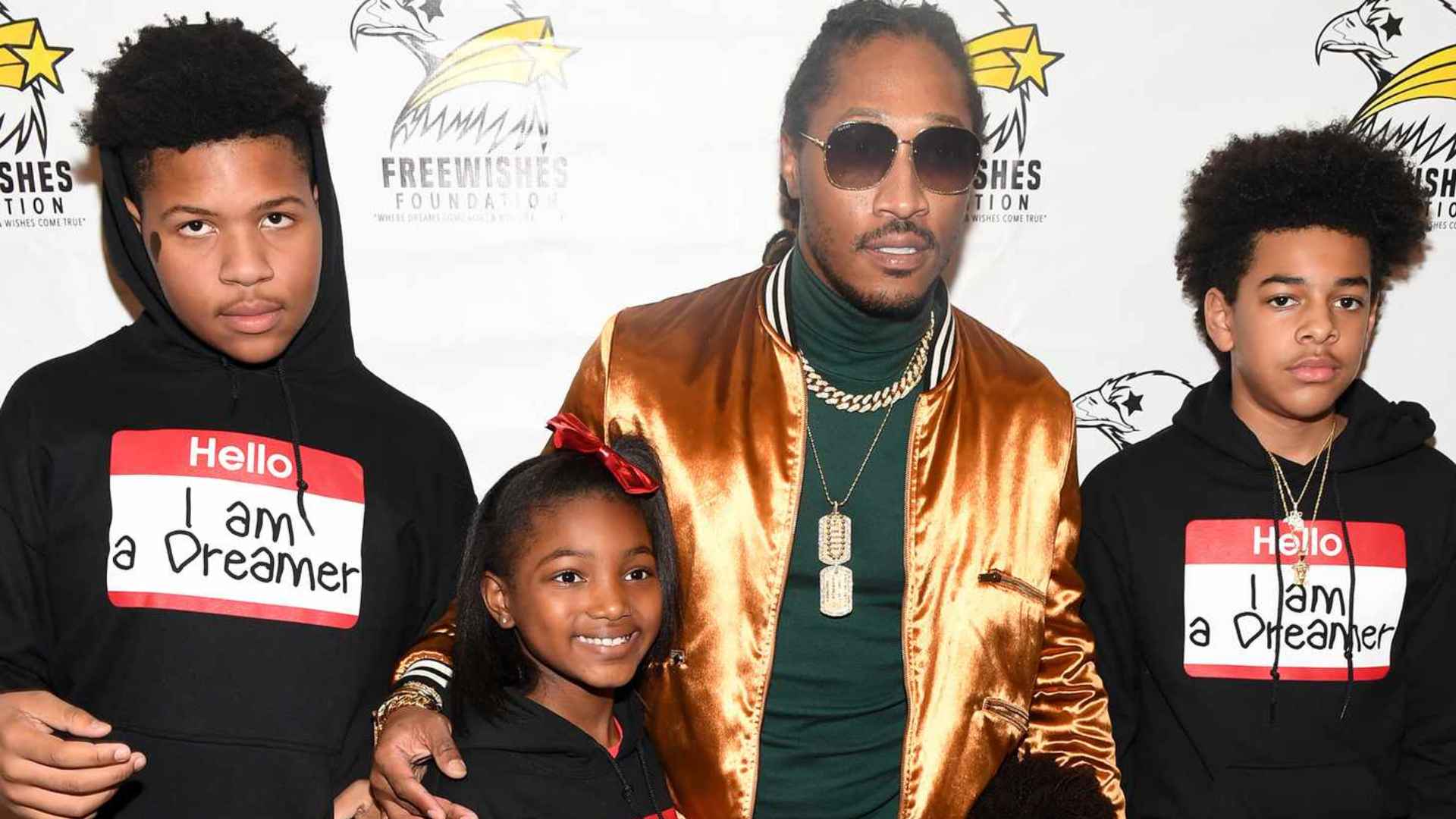 Future poses with his children at an event, standing together for a family photo with his sons and daughters.