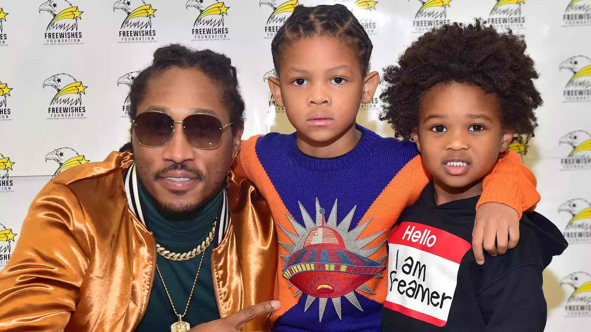 Future posing with Prince Wilburn and another child at a FreeWishes Foundation event.