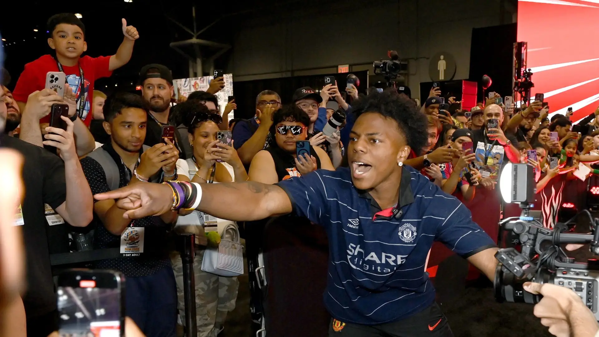 IShowSpeed interacting with fans during a live event surrounded by cameras phones and a large crowd