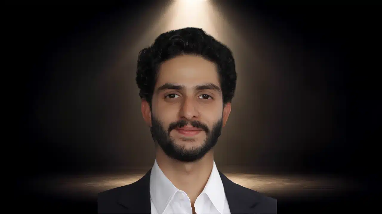 Headshot of Zahan Mistry with a beard, wearing a suit and open-collar white shirt.