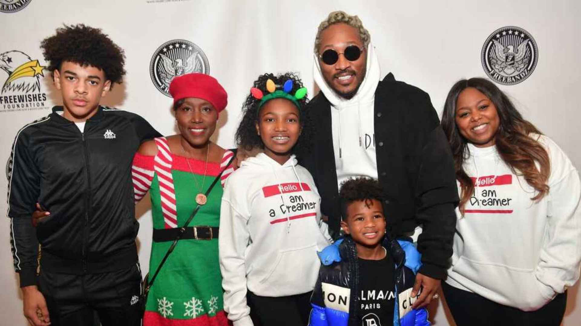 Future poses with his children at an event, including sons and daughters gathered for a family photo.