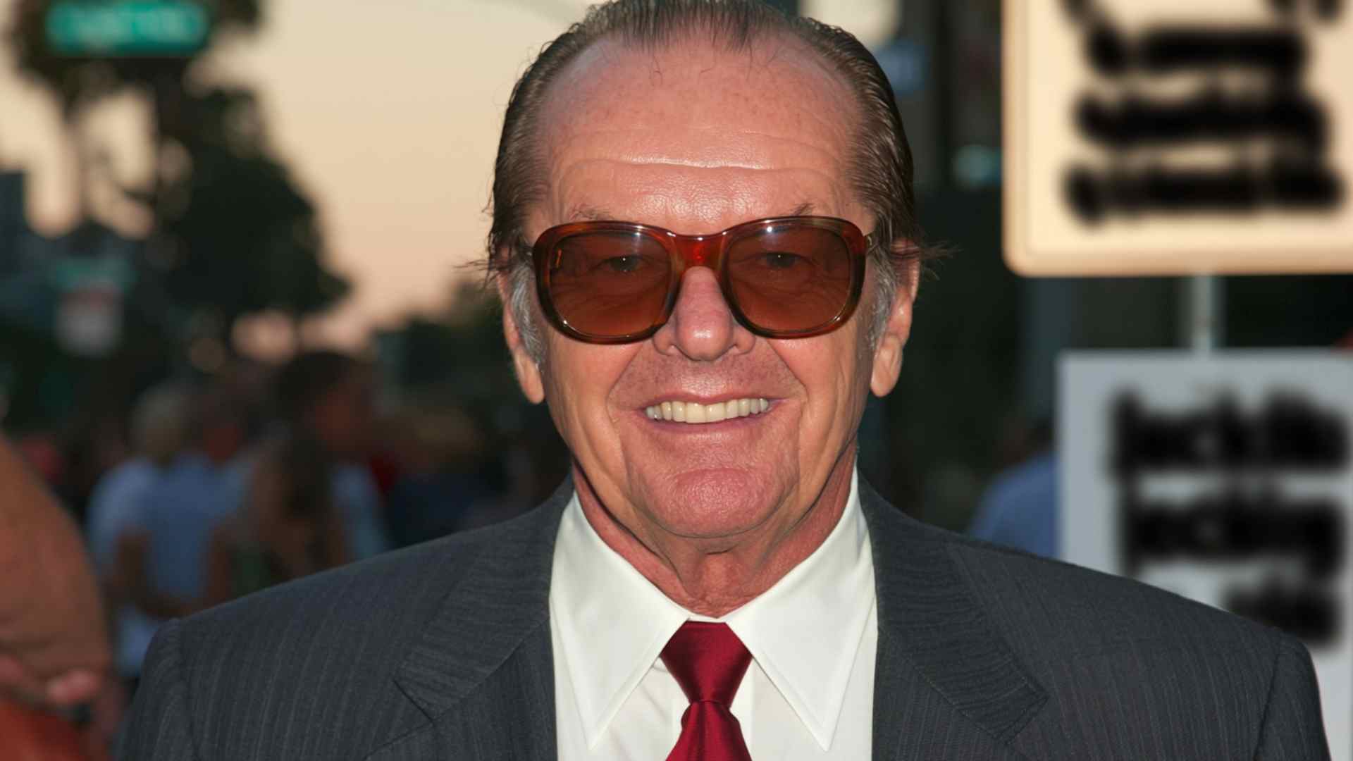 Jack Nicholson smiling at a Hollywood event showcasing his legendary acting career