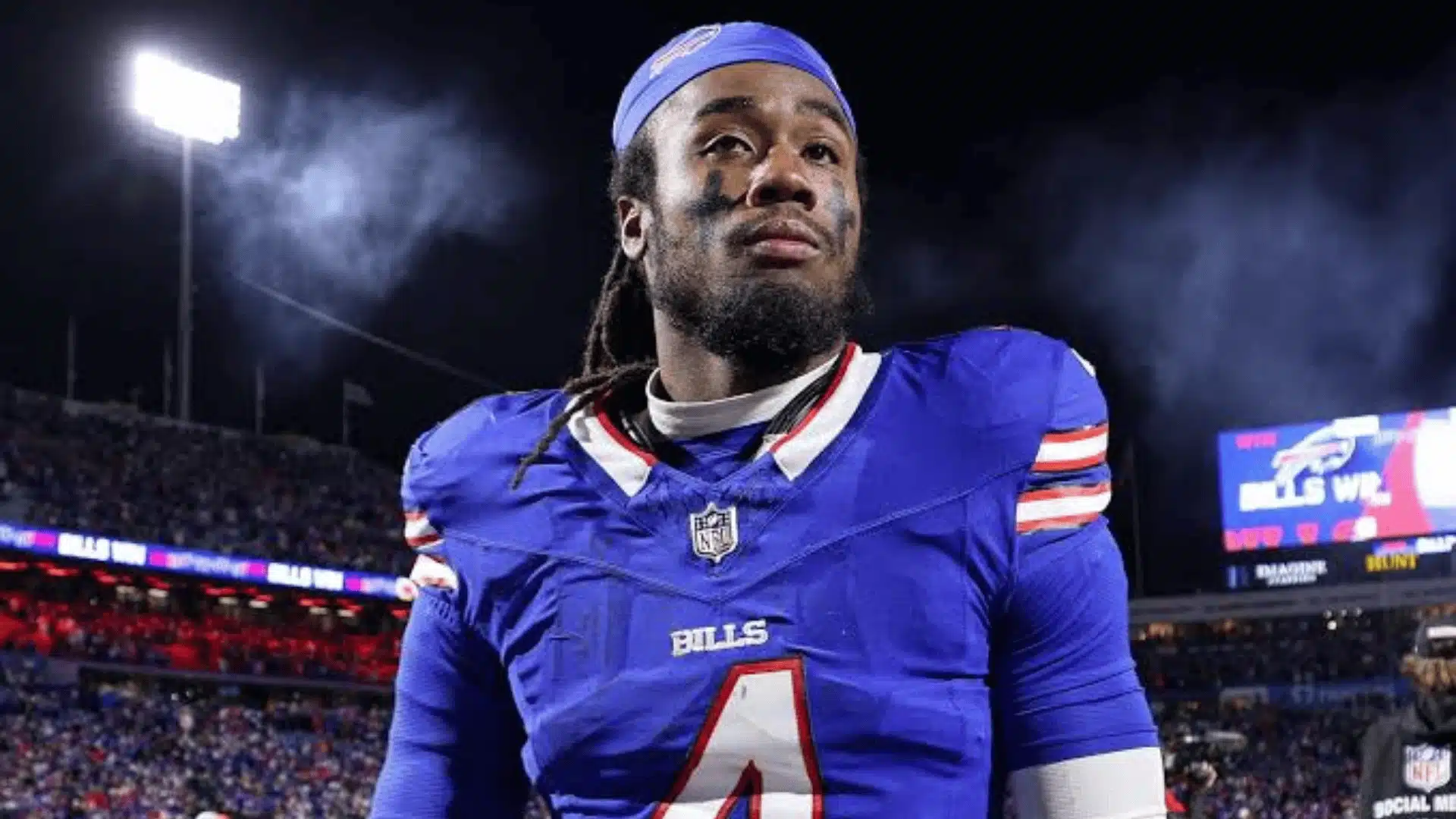 James Cook wearing a Buffalo Bills uniform on the field at night