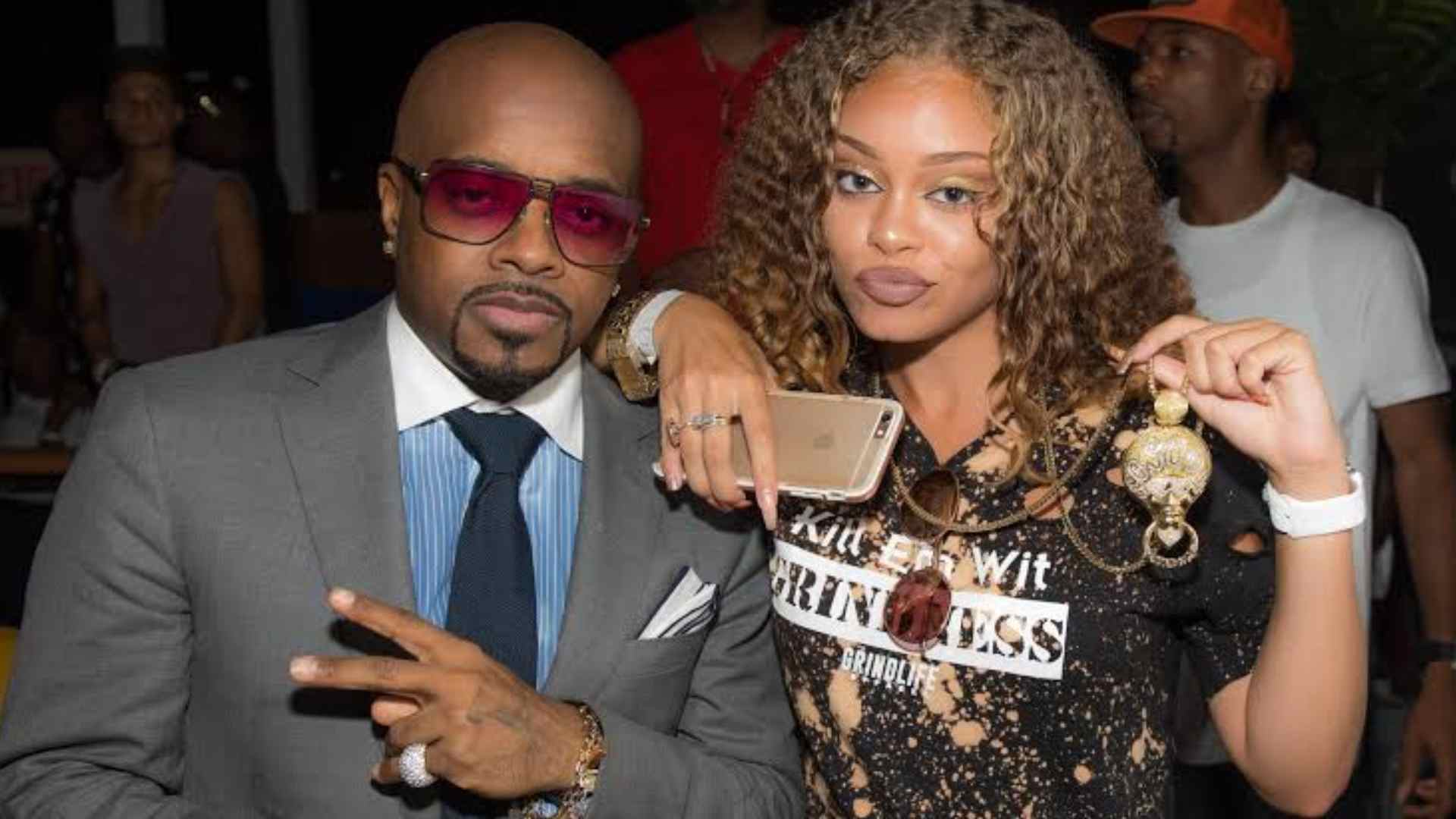 Latto posing with her father in a photo highlighting her early rap career journey