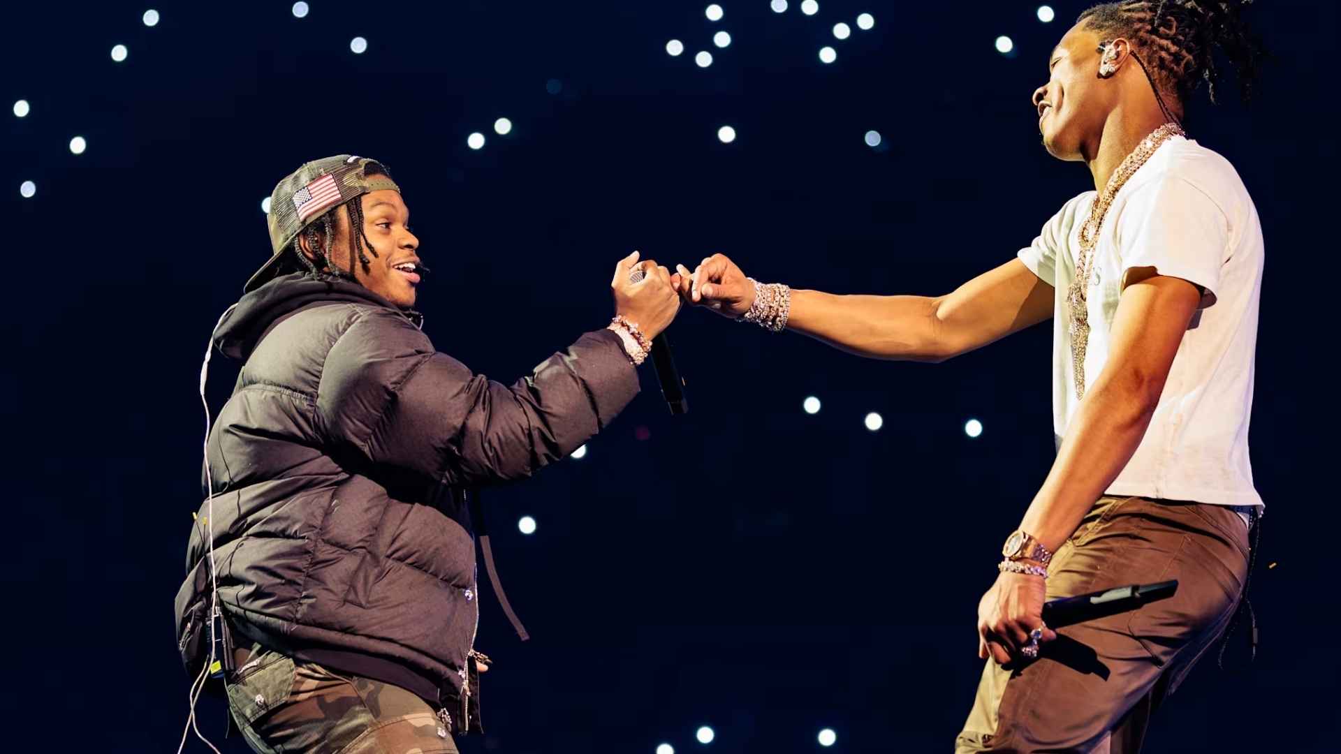 Lil Baby performing on stage with another rapper during a concert on his birthday