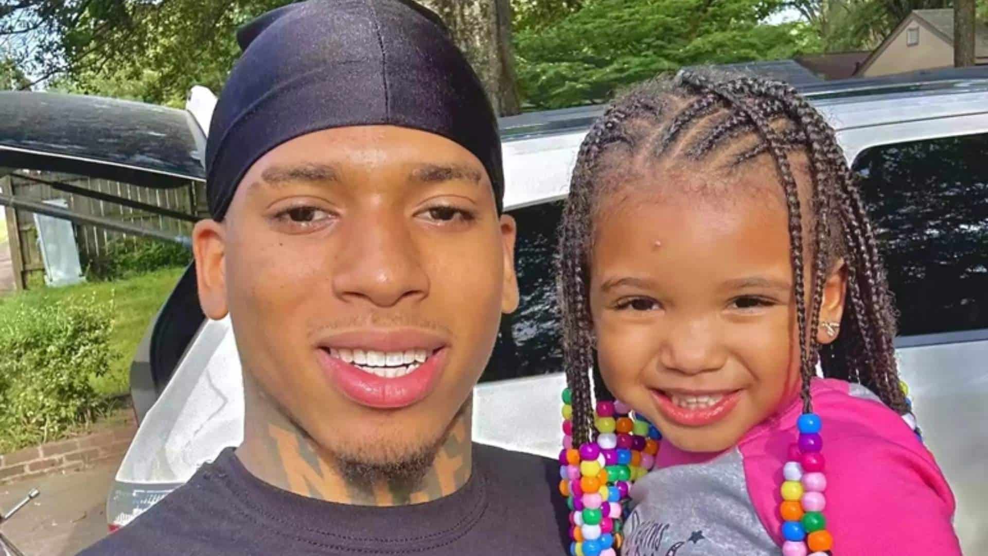 NLE Choppa with his daughter Clover Brylie Potts smiling together outdoors near a vehicle.