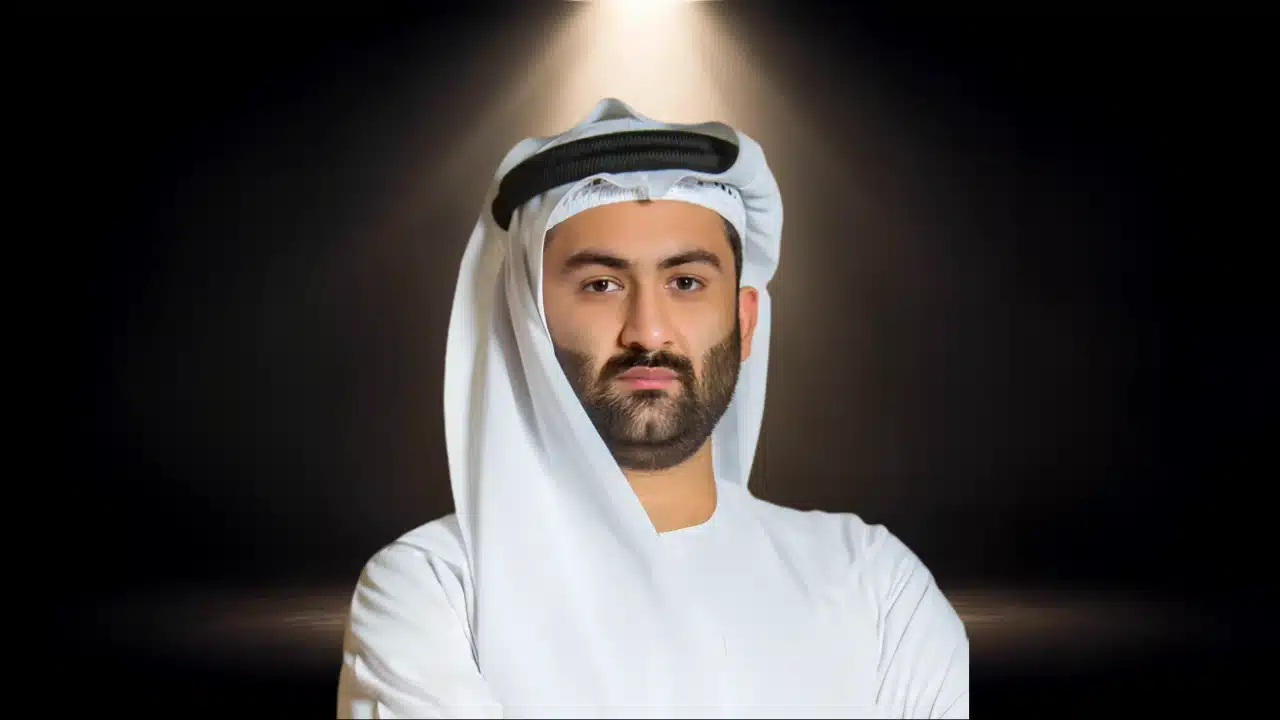 Portrait of Abbas Sajwani wearing traditional white Emirati attire under a subtle overhead spotlight.