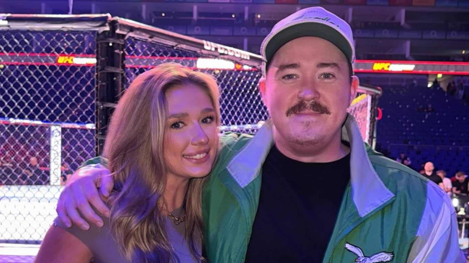 Shane Gillis and Grace Brassel posing together at a UFC event during their relationship