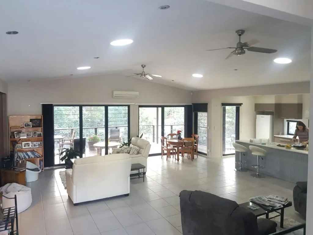 Spacious open-plan living room and kitchen with modern furniture and large windows