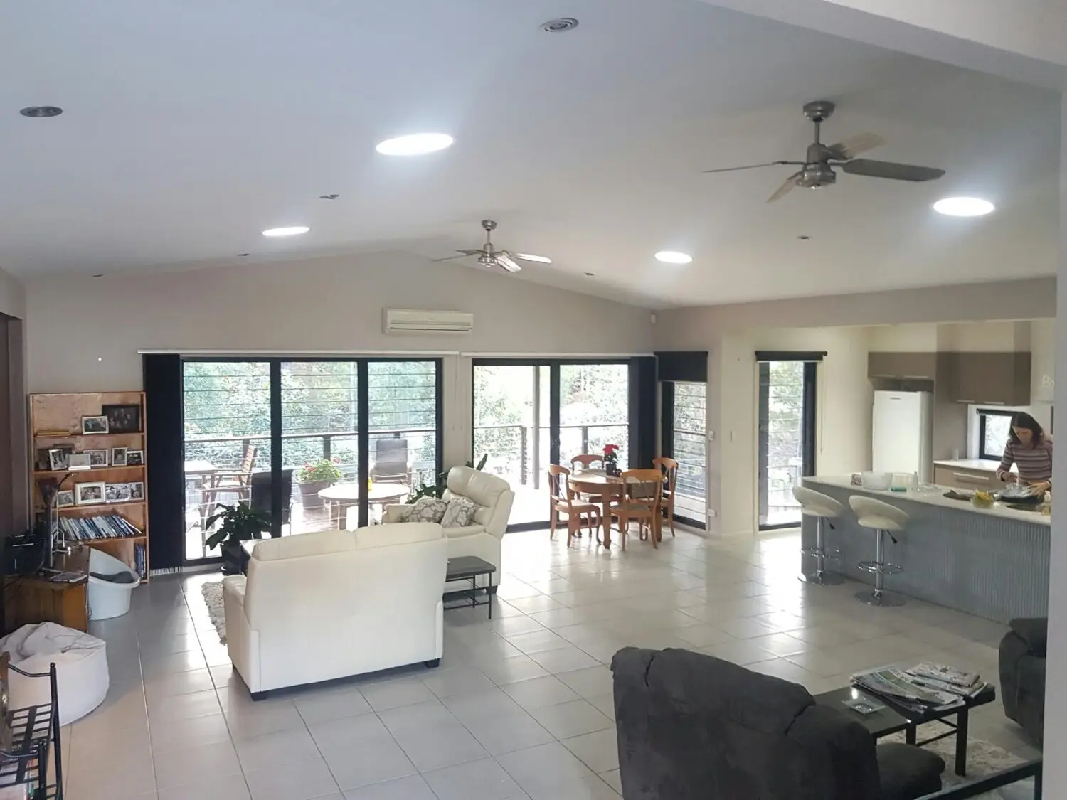 Spacious open-plan living room and kitchen with modern furniture and large windows
