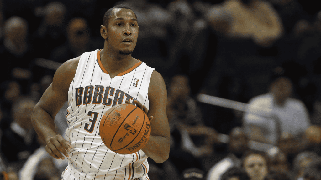 Boris Diaw dribbling a Spalding basketball while playing for the Charlotte Bobcats in a white pinstripe jersey.