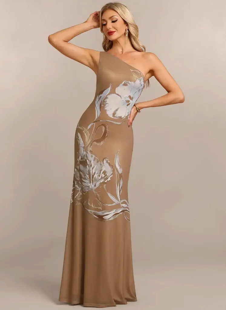 One-shoulder tan gown with white floral pattern in neutral studio setting