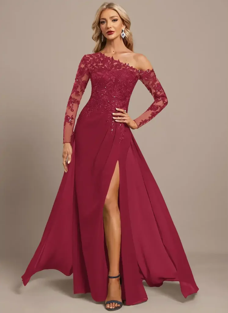 Elegant woman in burgundy evening gown with lace details and high slit, standing indoors