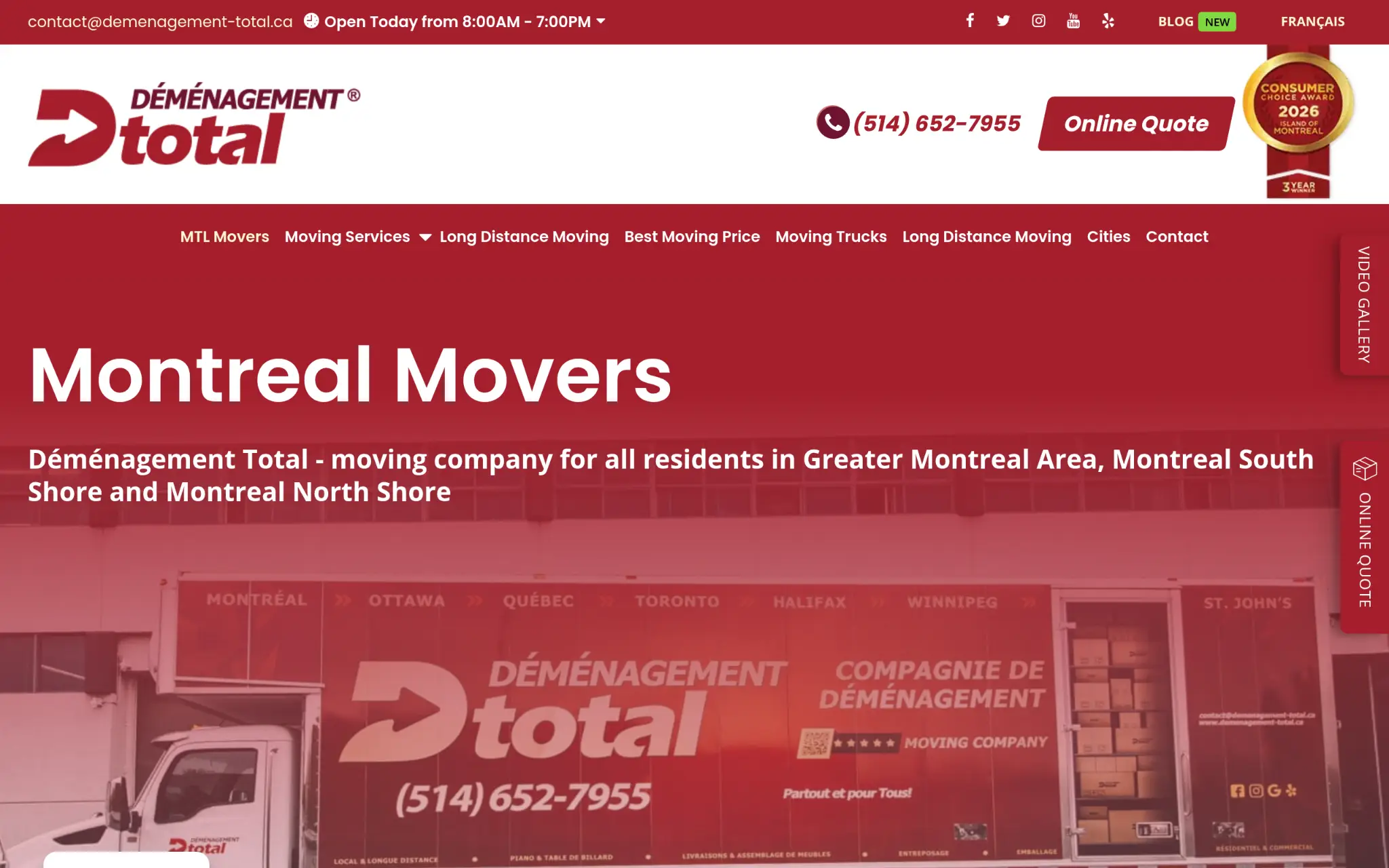 Moving truck with branding parked outside building in urban environment, red color scheme dominant