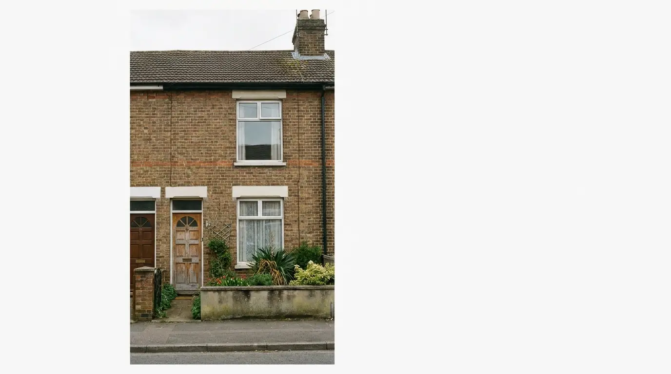 Brick townhouse with white trim and small garden on overcast day