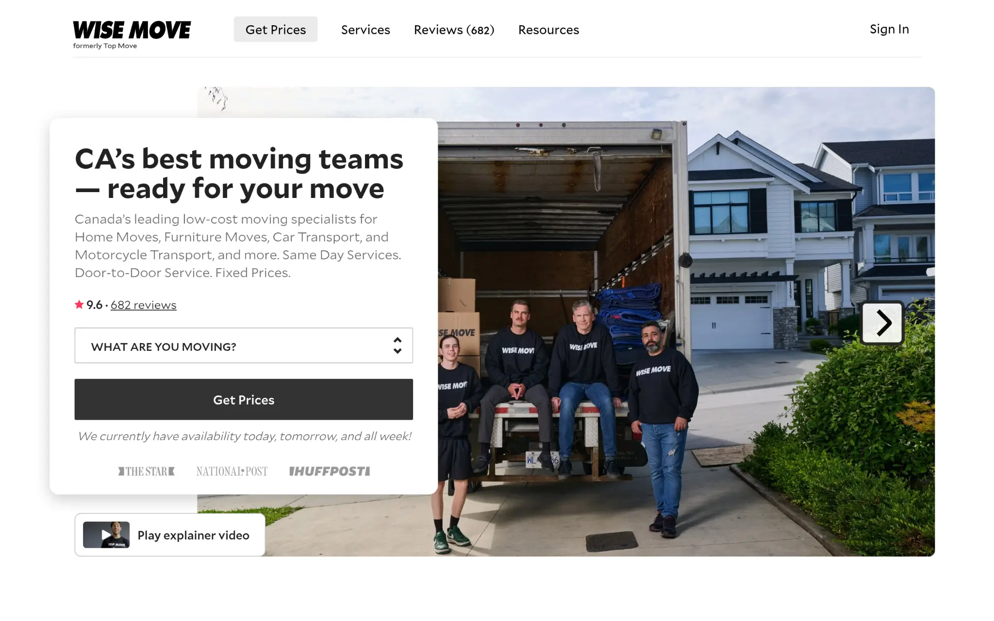 Moving team in matching uniforms standing by an open truck on a residential street