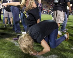 A CU fan kisses the grass after the win over Georgia.